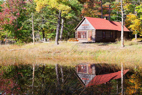 Log Cabin in Autumn Woods
